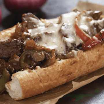 Cheesesteak Sandwiches with French Fries and Onion Rings