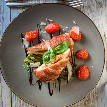 Chicken In Parma Ham, Stuffed With Mozzarella, Basil and Red Pesto With Polenta Chips