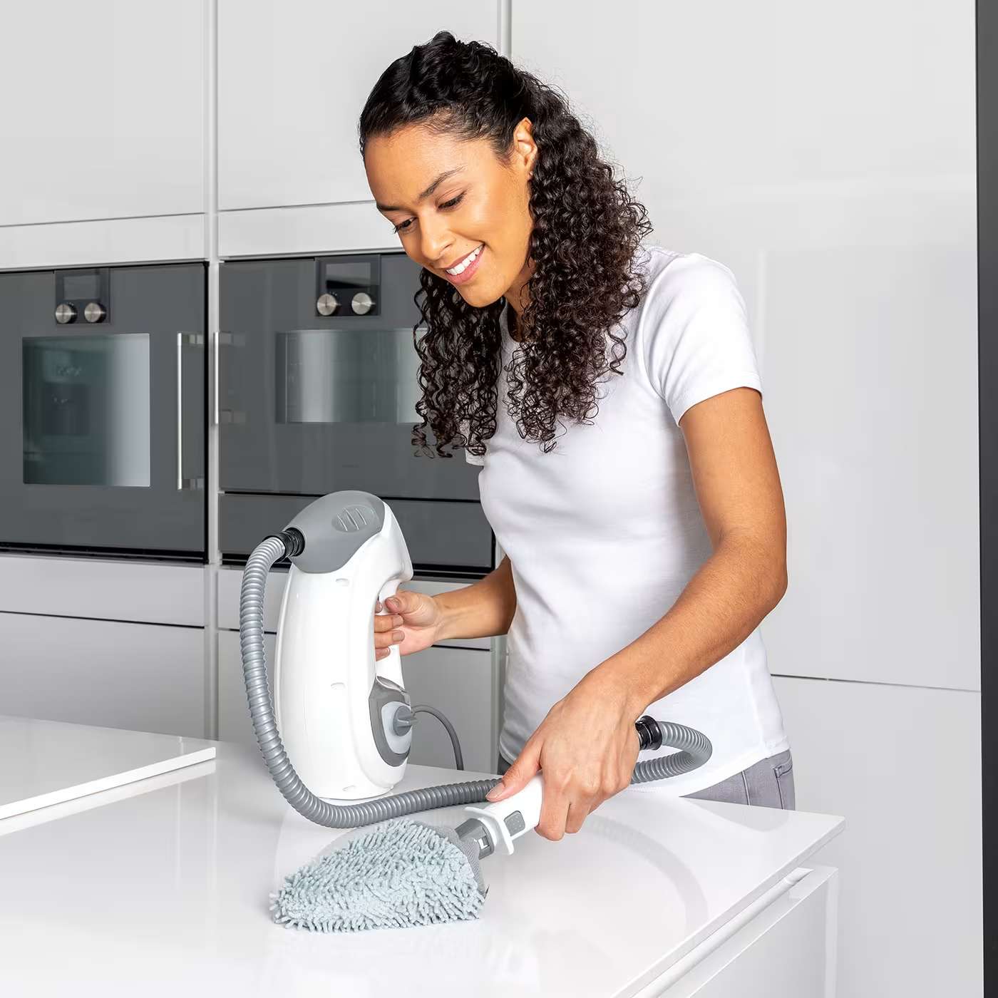 Women mopping worktop with handheld
