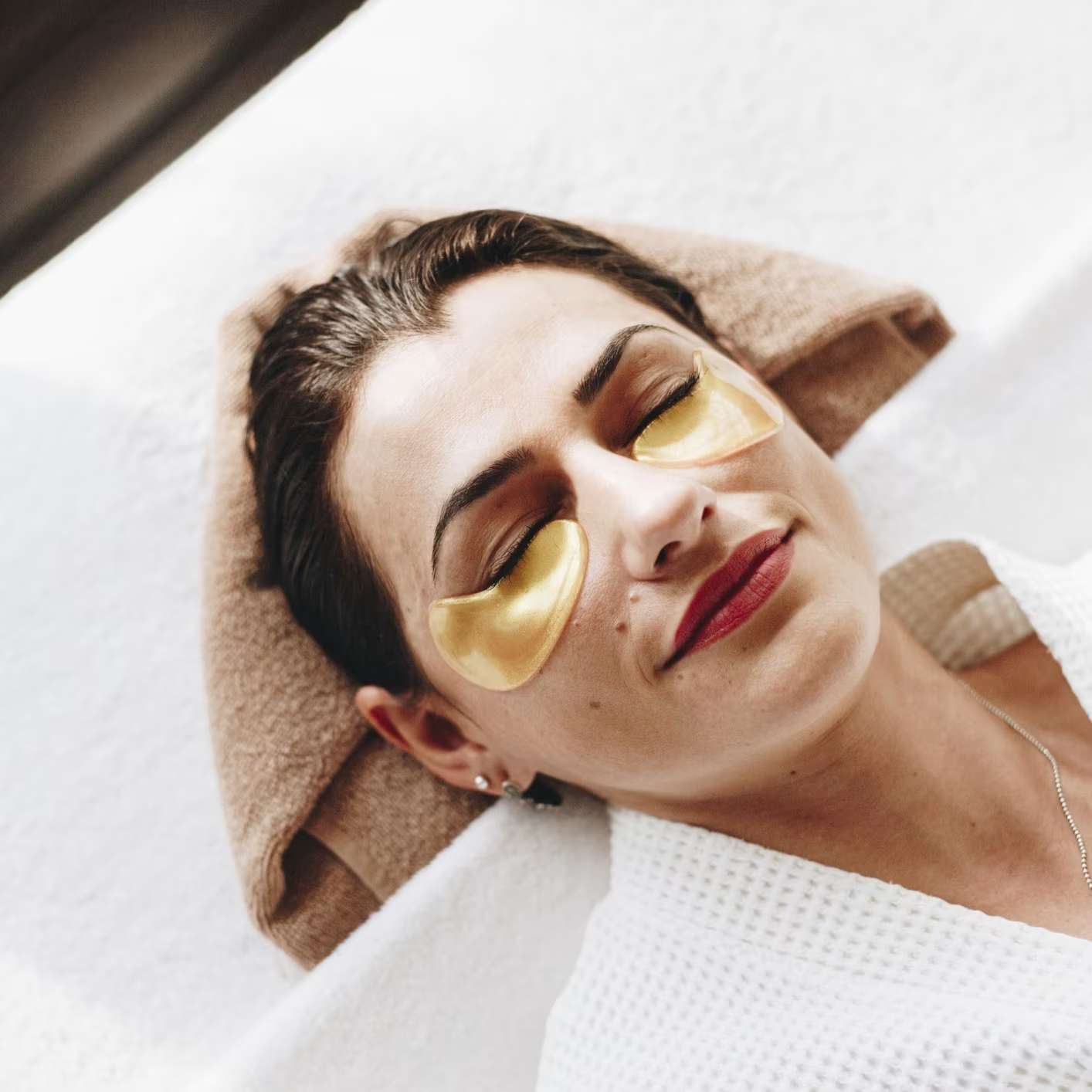 Woman relaxing with under eye pads