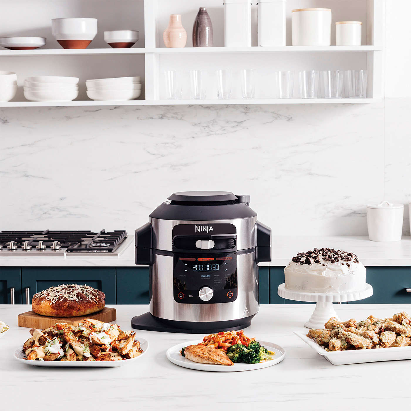 Multicooker Ninja Foodie MAX SmartLid 14 w 1 OL750EU stojący na blacie w kuchni z wieloma gotowymi potrawami obok