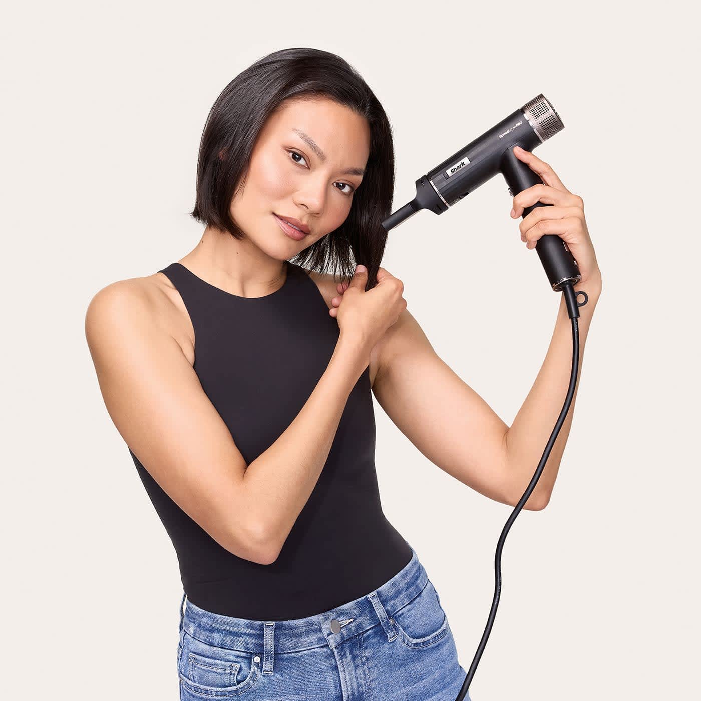 Femme utilisant le s&egrave;che-cheveux Shark sur cheveux courts
