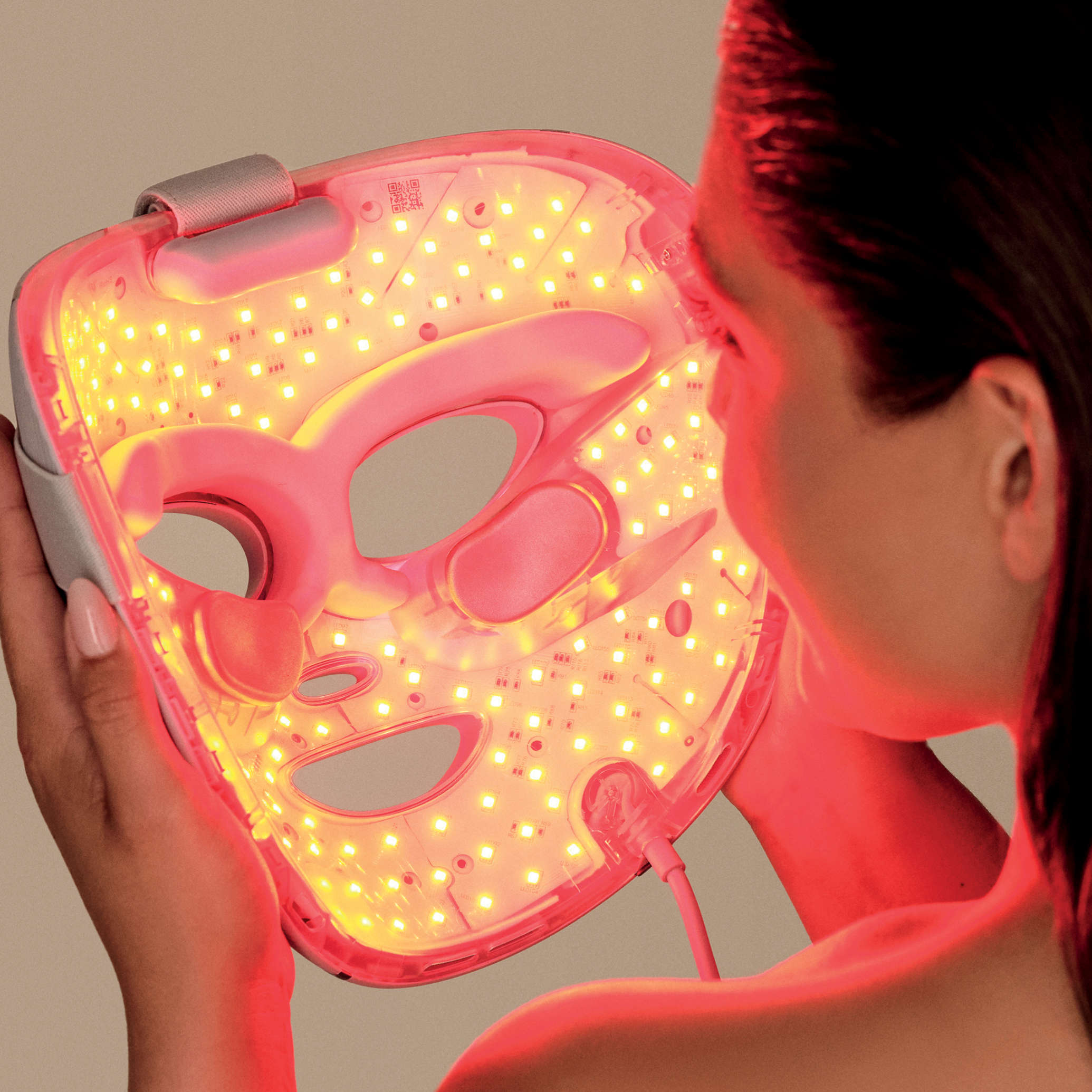 Femme tenant le masque LED Shark avec lumi&egrave;re rouge.