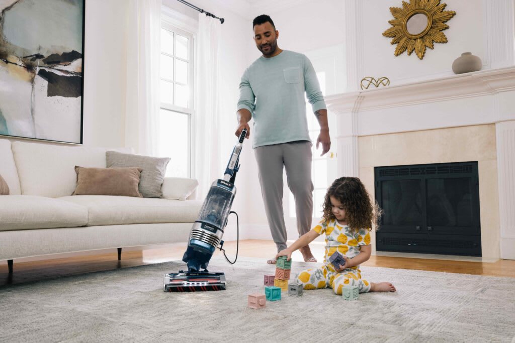 Upright Vacuum in-use in a Living Room