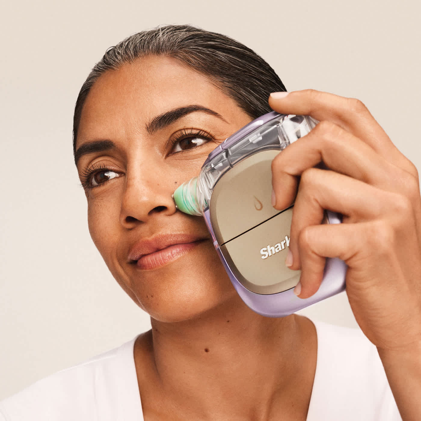 Women using the the Shark FacialPro Glow at home facial system